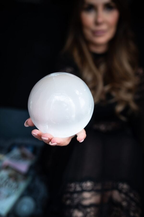 Anne-Marie mayers creator of Quantum Holographic Echo Healing holding a glowing crystal sphere symbolising quantum holographic echo healing and energy based healing