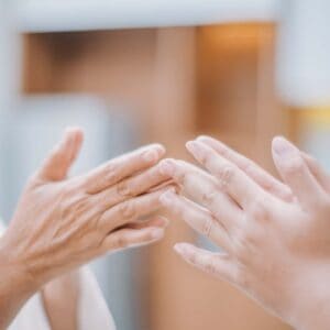 Hands in an mindful gesture during a meditation practice, representing calmness and connection - featured in the Meditation Teacher Toolkit Course.