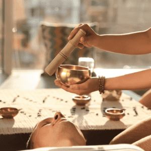 Hands preparing a spiritual ritual with candles and crystals on a table – accredited online chakra healing and spiritual coaching courses by Soul Awakening Academy.