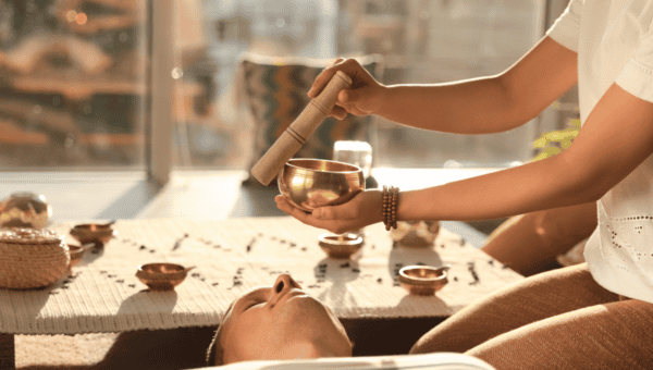 Hands preparing a spiritual ritual with candles and crystals on a table – accredited online chakra healing and spiritual coaching courses by Soul Awakening Academy.