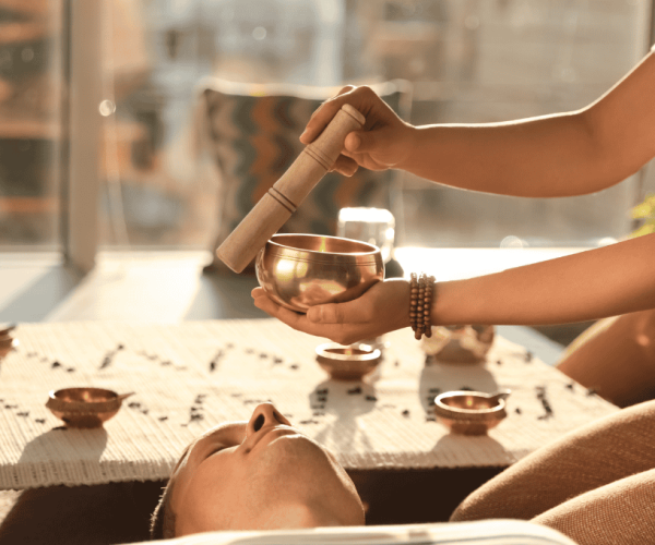 Hands preparing a spiritual ritual with candles and crystals on a table – accredited online chakra healing and spiritual coaching courses by Soul Awakening Academy.